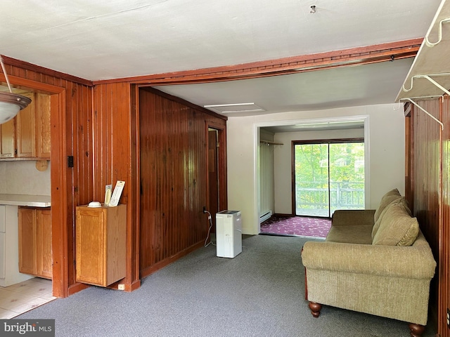 living room with wooden walls and light colored carpet