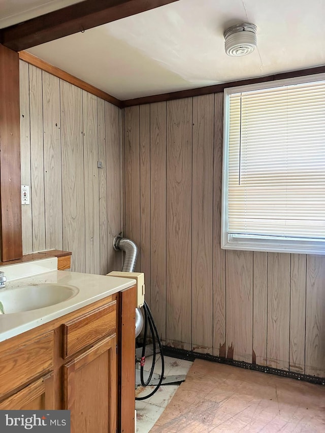 bathroom featuring wood walls and vanity