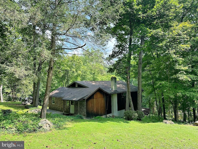 view of front of home with a front lawn and a chimney