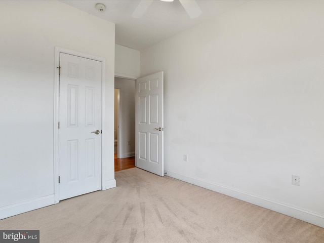 unfurnished bedroom featuring ceiling fan and light colored carpet