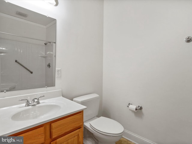 bathroom with vanity, toilet, and walk in shower