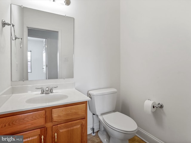 bathroom with tile patterned flooring, vanity, and toilet