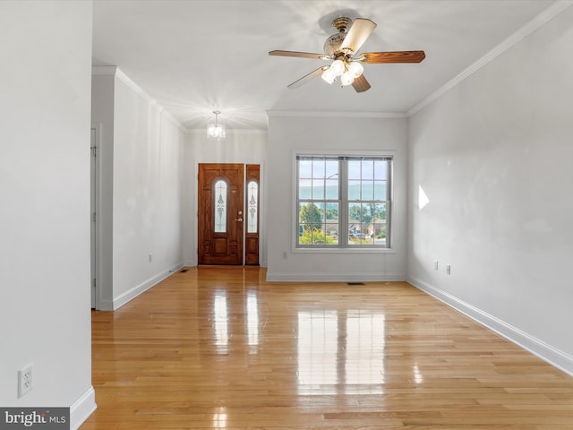 foyer featuring crown molding, ceiling fan with notable chandelier, and light wood-type flooring