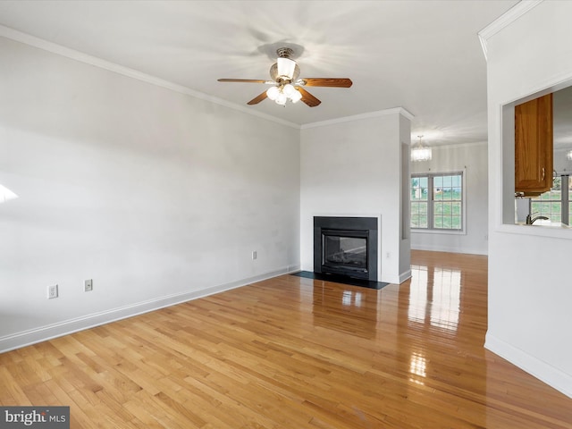 unfurnished living room with light hardwood / wood-style flooring, ceiling fan with notable chandelier, and ornamental molding