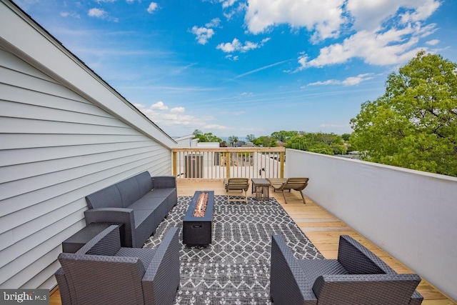 wooden terrace featuring an outdoor living space