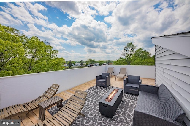 deck with an outdoor living space with a fire pit