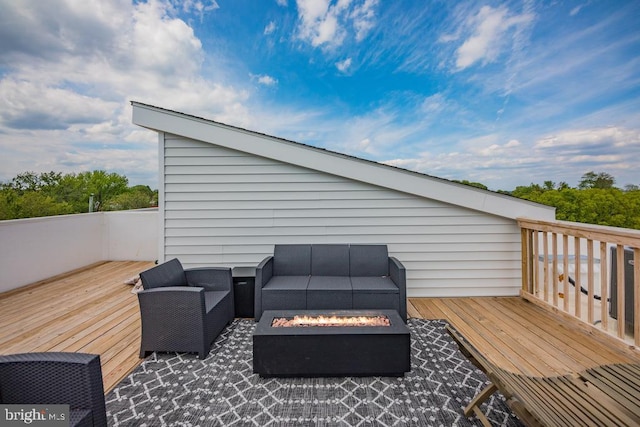 wooden deck featuring an outdoor living space with a fire pit