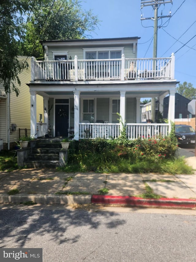 view of front of house with a porch and a balcony