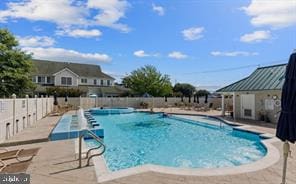 view of swimming pool with a patio area