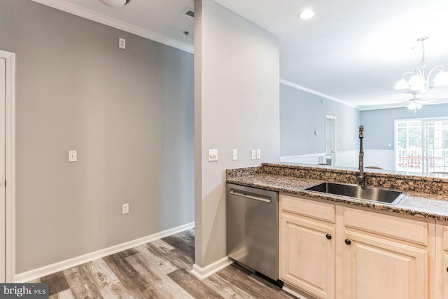 kitchen featuring sink, dark stone countertops, light hardwood / wood-style flooring, and dishwasher