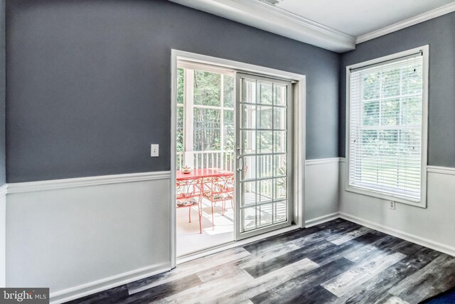 doorway featuring a wealth of natural light, hardwood / wood-style flooring, and ornamental molding