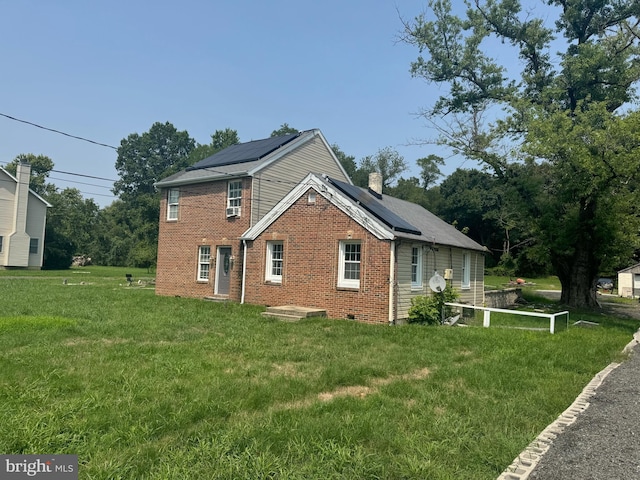 view of property exterior with solar panels and a yard