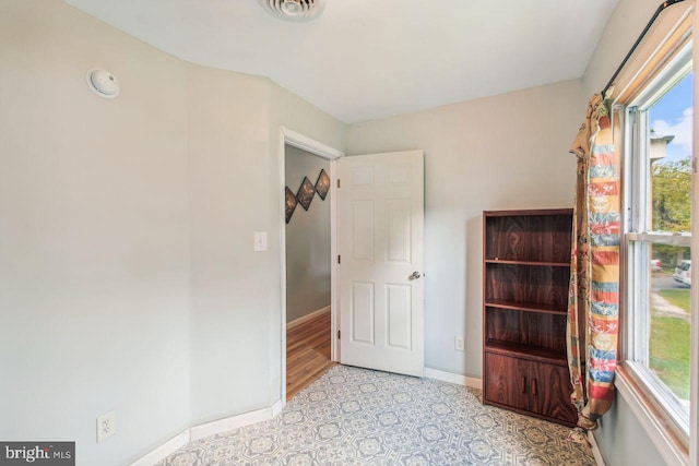 unfurnished bedroom featuring visible vents and baseboards