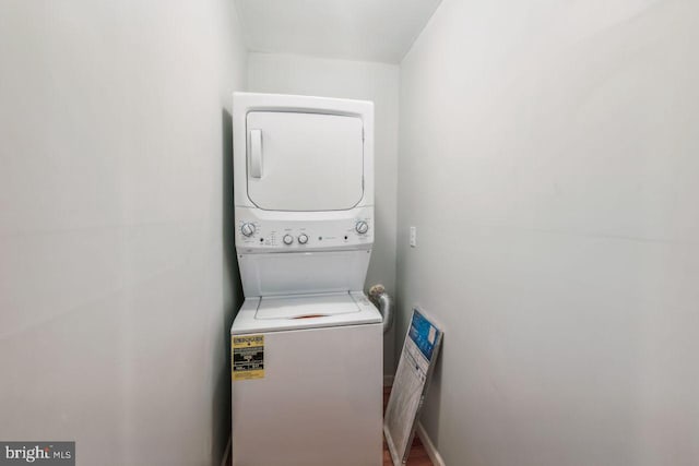 laundry area featuring stacked washer / drying machine and laundry area