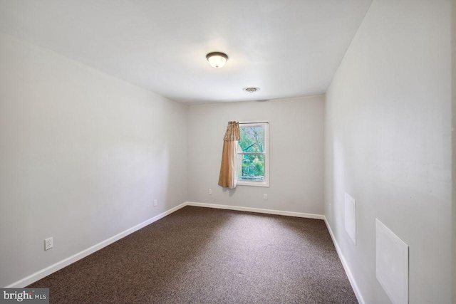 carpeted empty room featuring visible vents and baseboards