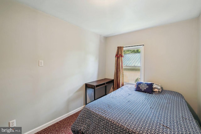 bedroom with carpet and baseboards