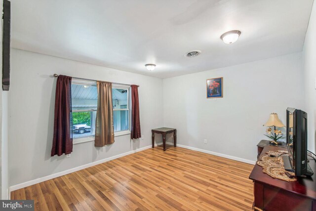 unfurnished room with wood-type flooring