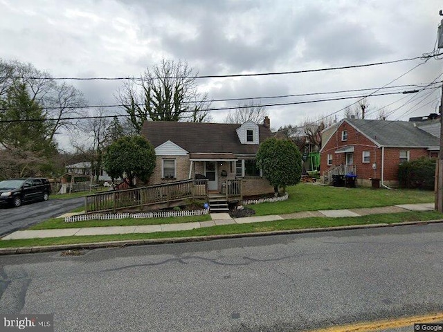 cape cod home with a front lawn