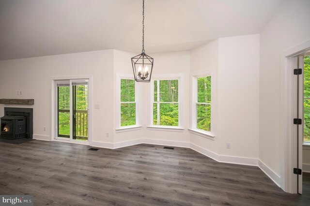 unfurnished dining area with crown molding, dark hardwood / wood-style floors, and a chandelier