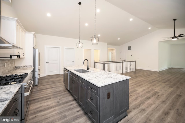 kitchen featuring white cabinetry, an island with sink, lofted ceiling, ceiling fan, and sink