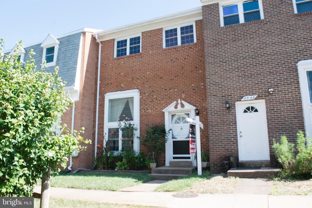 view of property featuring brick siding