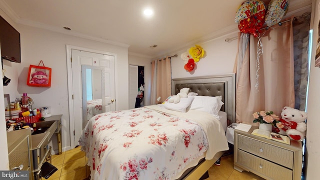 bedroom with ornamental molding and light tile patterned floors