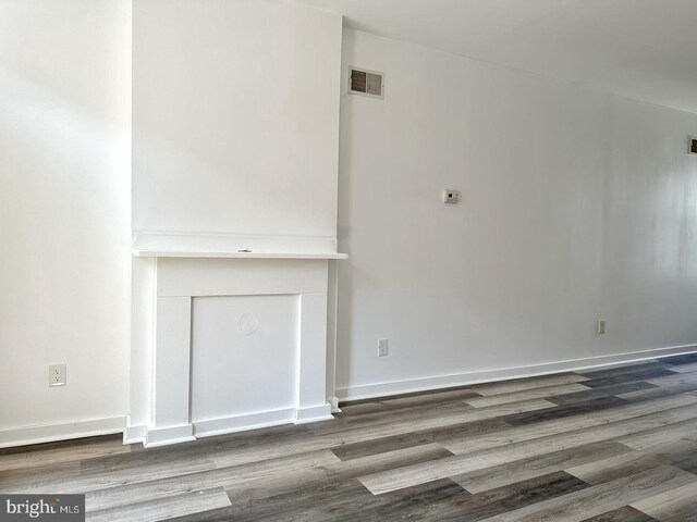 unfurnished living room with hardwood / wood-style floors