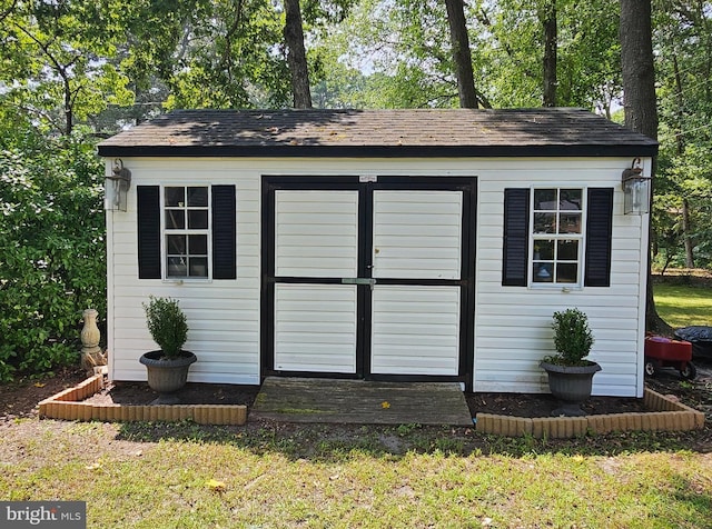 view of outdoor structure featuring a lawn