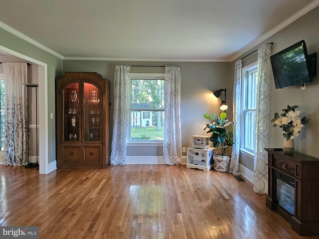 interior space with hardwood / wood-style flooring and crown molding