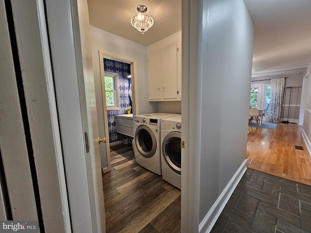 washroom with cabinets, dark wood-type flooring, and washer and clothes dryer