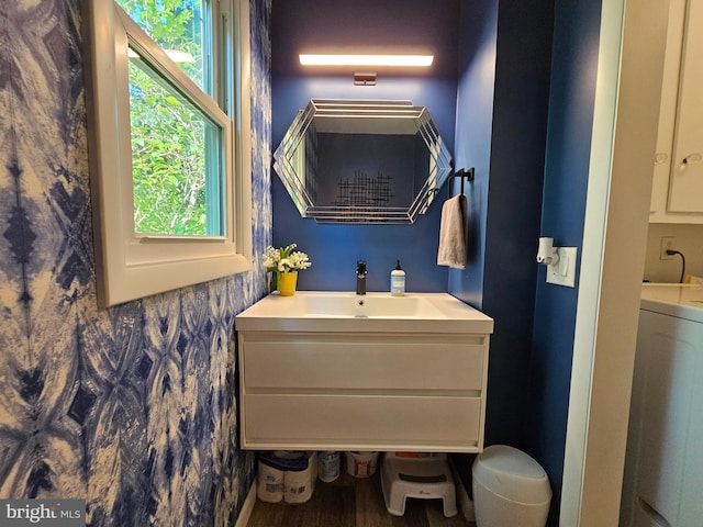 bathroom featuring wood-type flooring, washer / dryer, and vanity