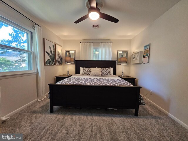 carpeted living room featuring ceiling fan, crown molding, and french doors