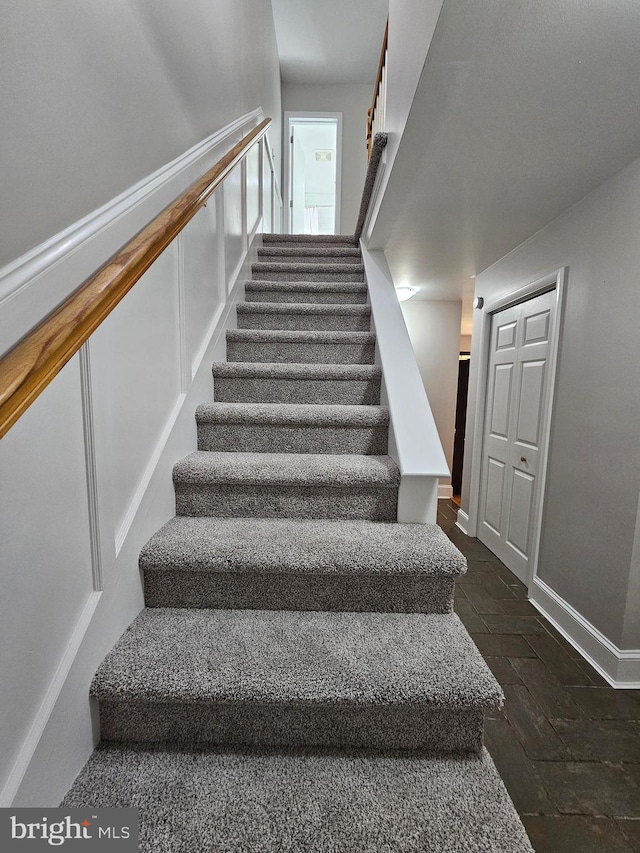 staircase with hardwood / wood-style flooring