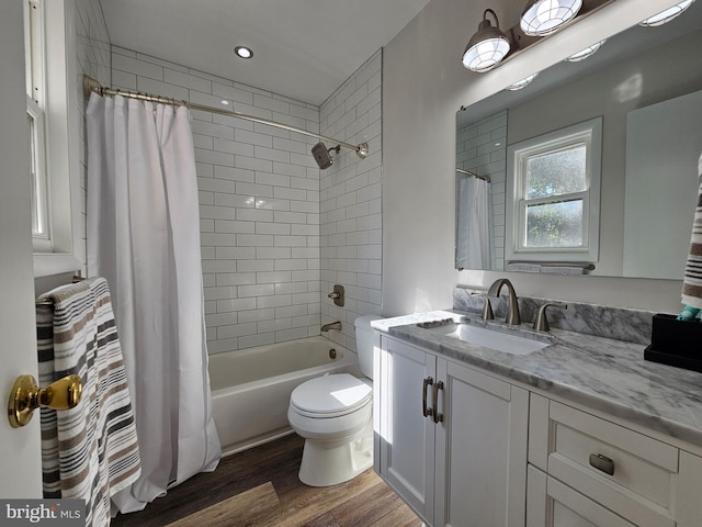 full bathroom featuring shower / tub combo with curtain, toilet, vanity, and wood-type flooring