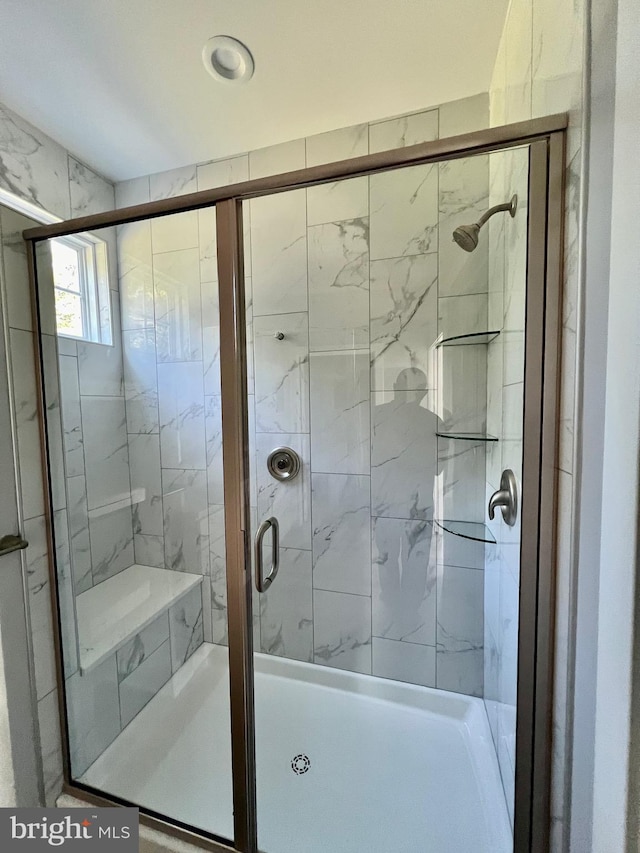 full bathroom featuring a shower stall