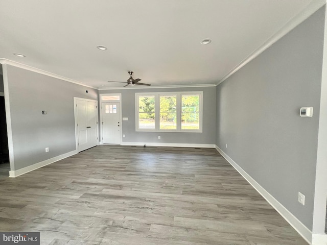 unfurnished living room featuring recessed lighting, light wood-style flooring, ornamental molding, ceiling fan, and baseboards