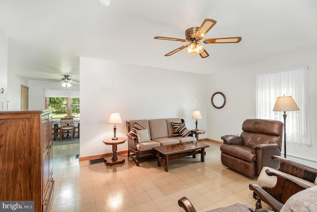 living room with light tile patterned flooring and ceiling fan