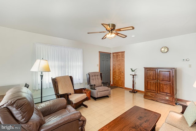 tiled living room featuring ceiling fan and a baseboard radiator