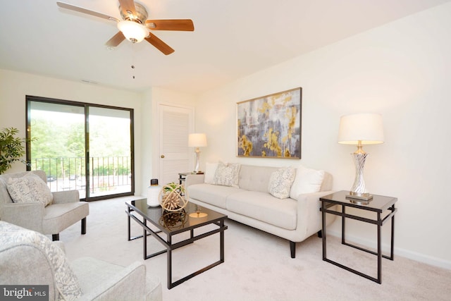 carpeted living room featuring ceiling fan