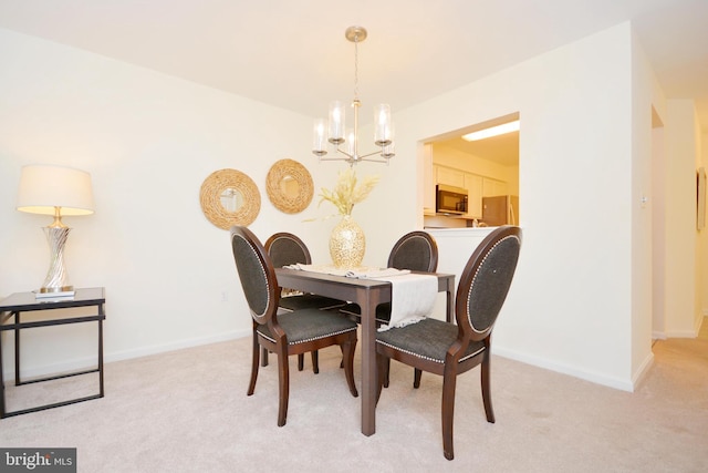 dining area featuring light carpet and an inviting chandelier