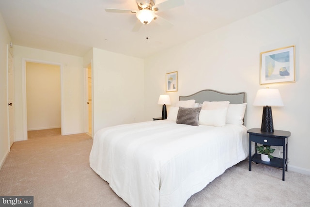 bedroom featuring light colored carpet and ceiling fan