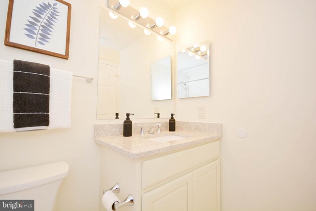 bathroom featuring toilet and vanity