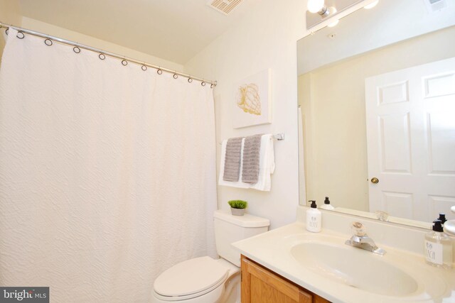 bathroom featuring toilet and vanity