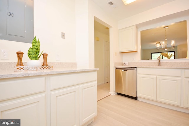 kitchen featuring light hardwood / wood-style flooring, white cabinetry, stainless steel dishwasher, and light stone counters