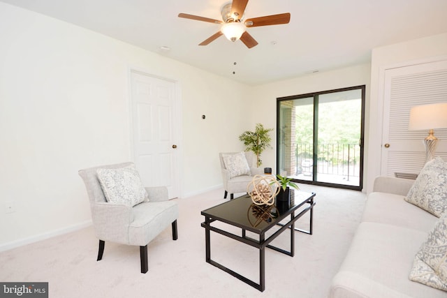 living room with ceiling fan and light carpet