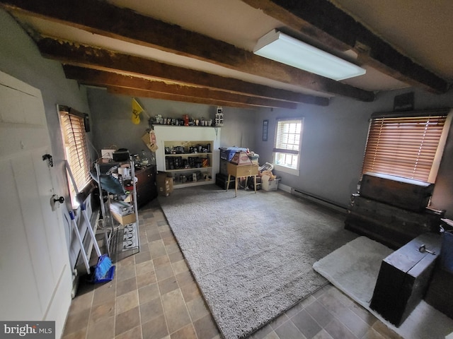 interior space with a baseboard radiator and beam ceiling