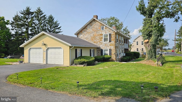 view of front of home with a garage and a front yard