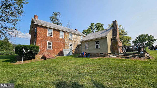 rear view of house featuring a yard