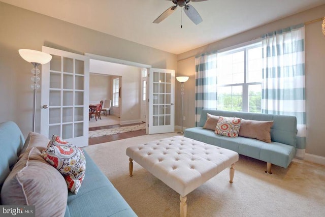 living room with ceiling fan, carpet floors, and french doors