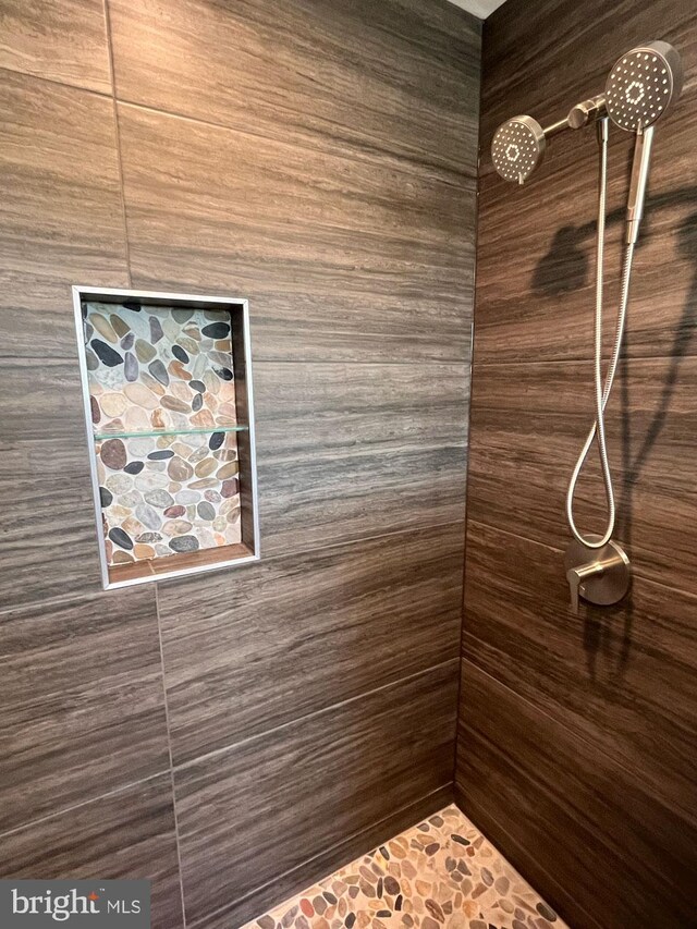 bathroom with toilet and an enclosed shower